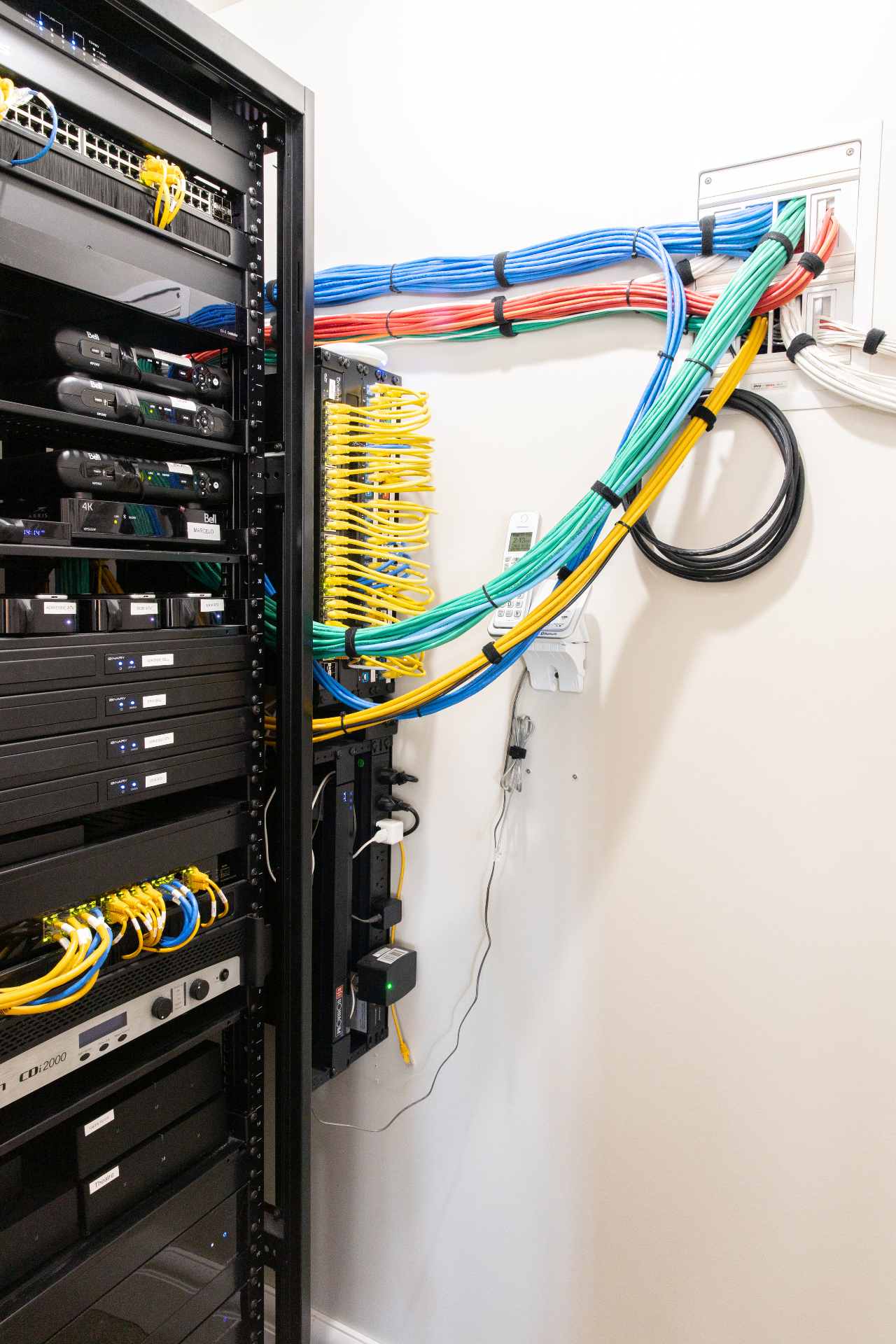 Professional equipment rack with color-coded structured cabling and clean cable management