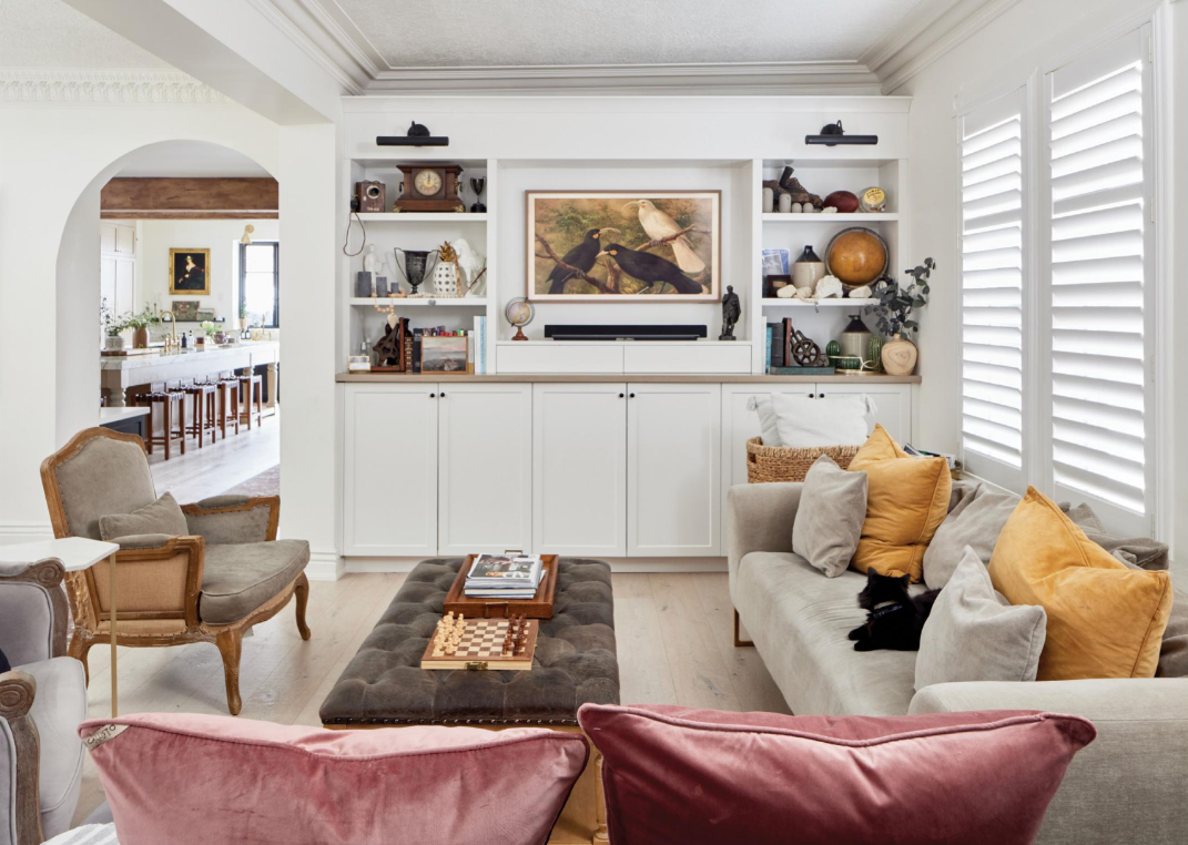 Bright family room with built-in shelving, artwork and integrated soundbar