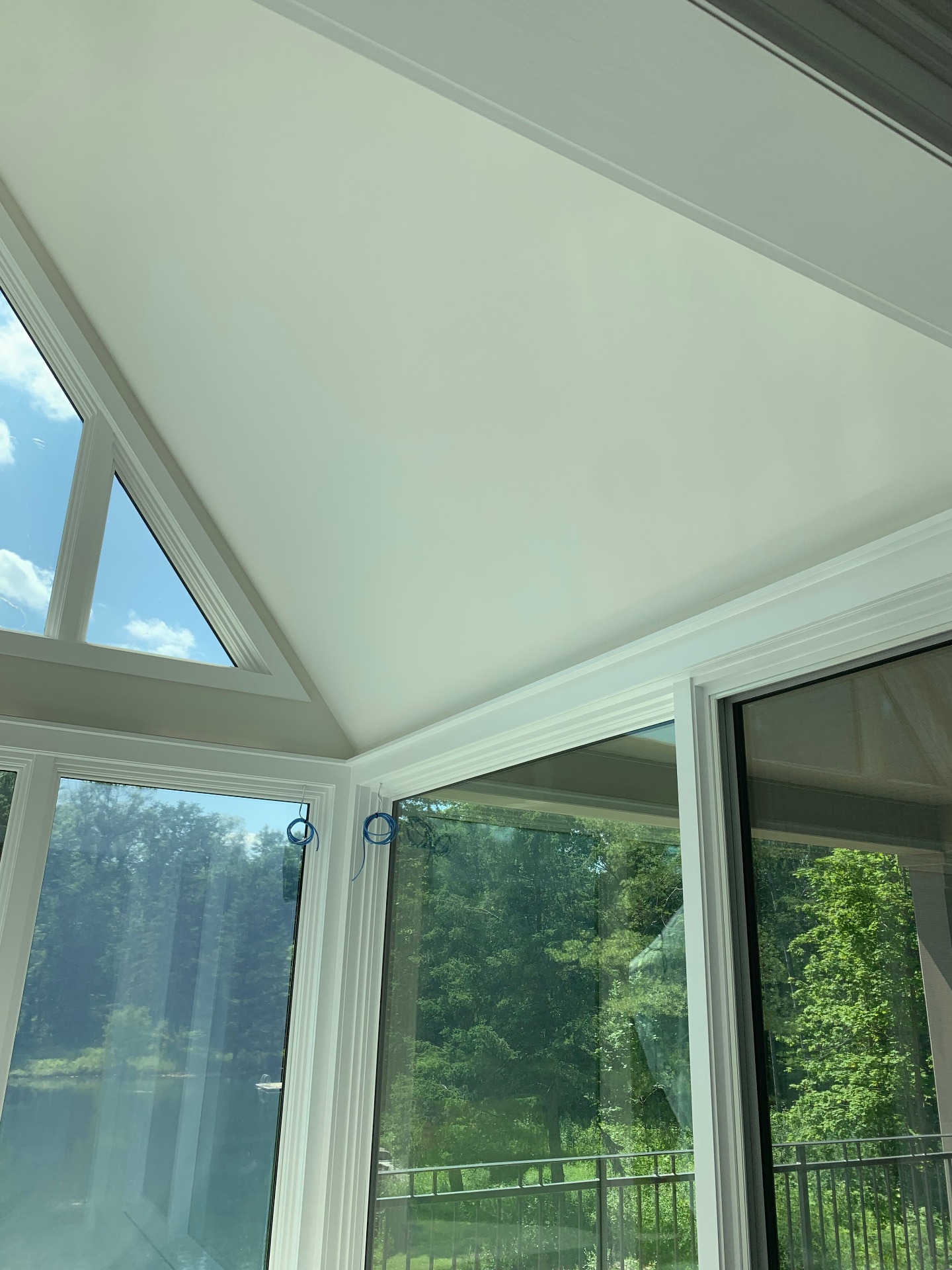 Finished sunroom corner with fully concealed in-ceiling audio