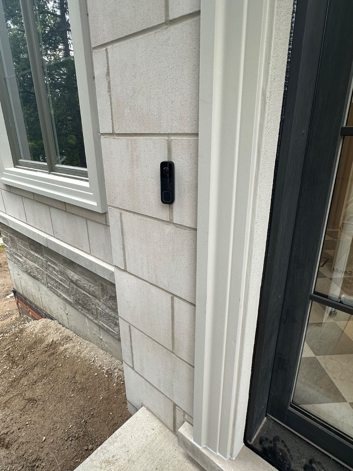 Video doorbell at the front entry of a custom home
