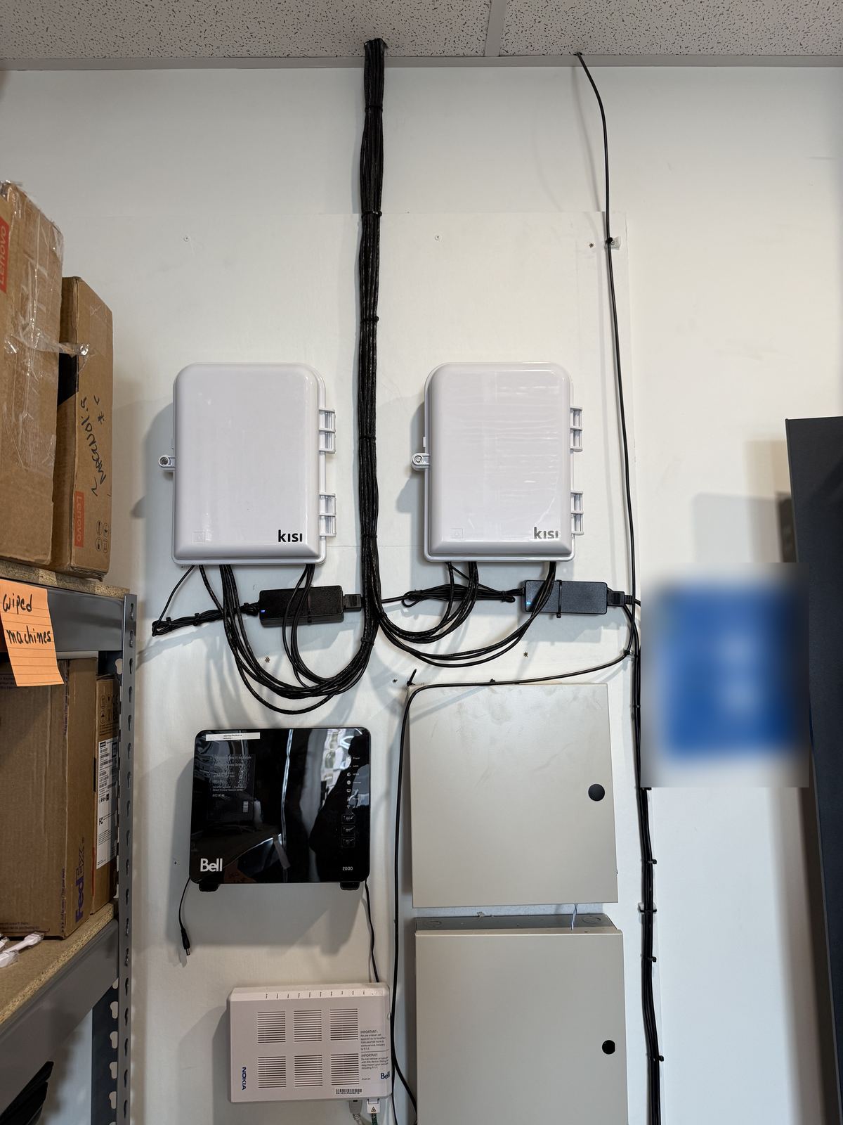 Kisi access control controllers wall-mounted in an office equipment room