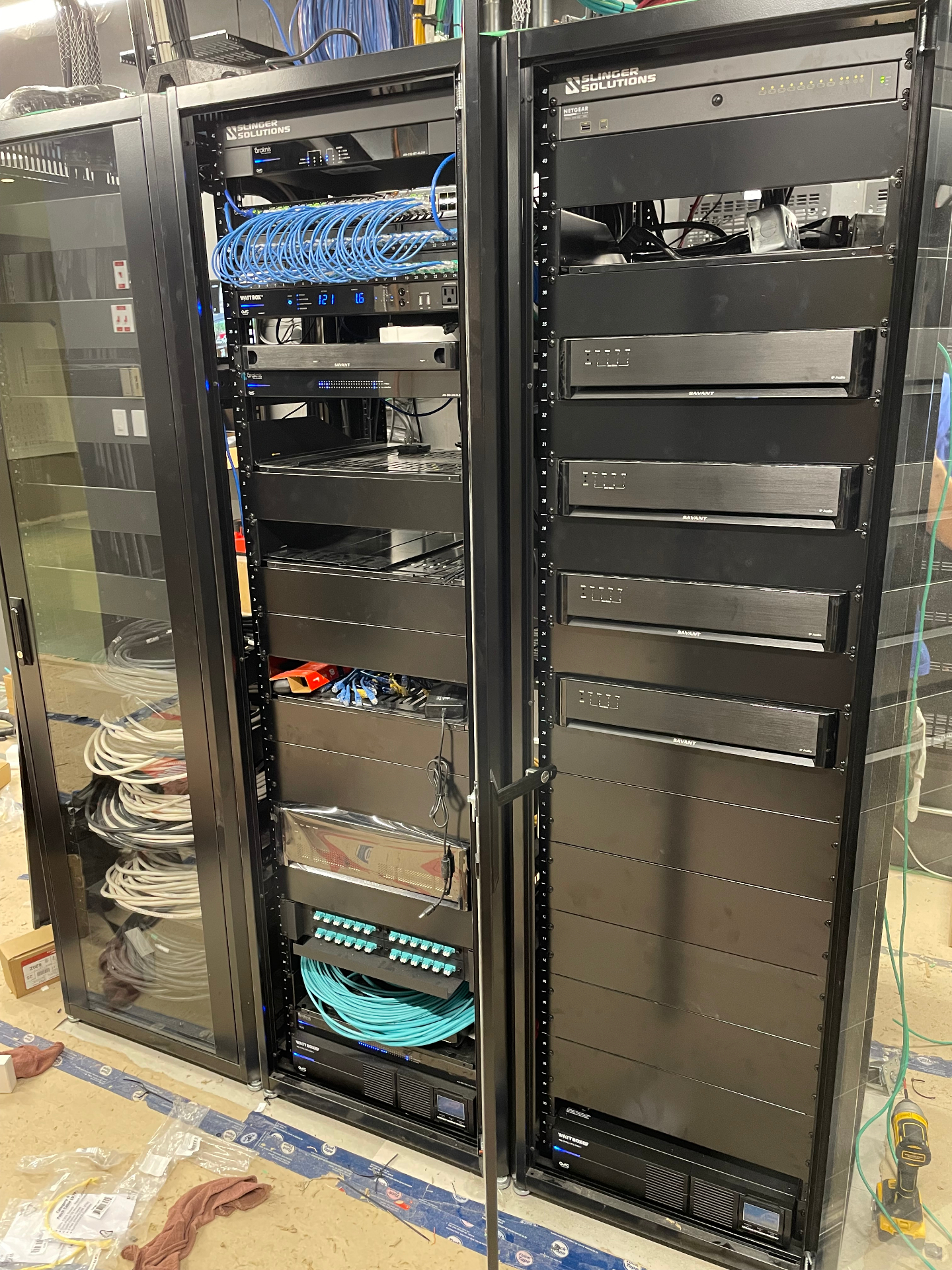 Custom Slinger Solutions equipment rack with Savant and networking gear during finishing