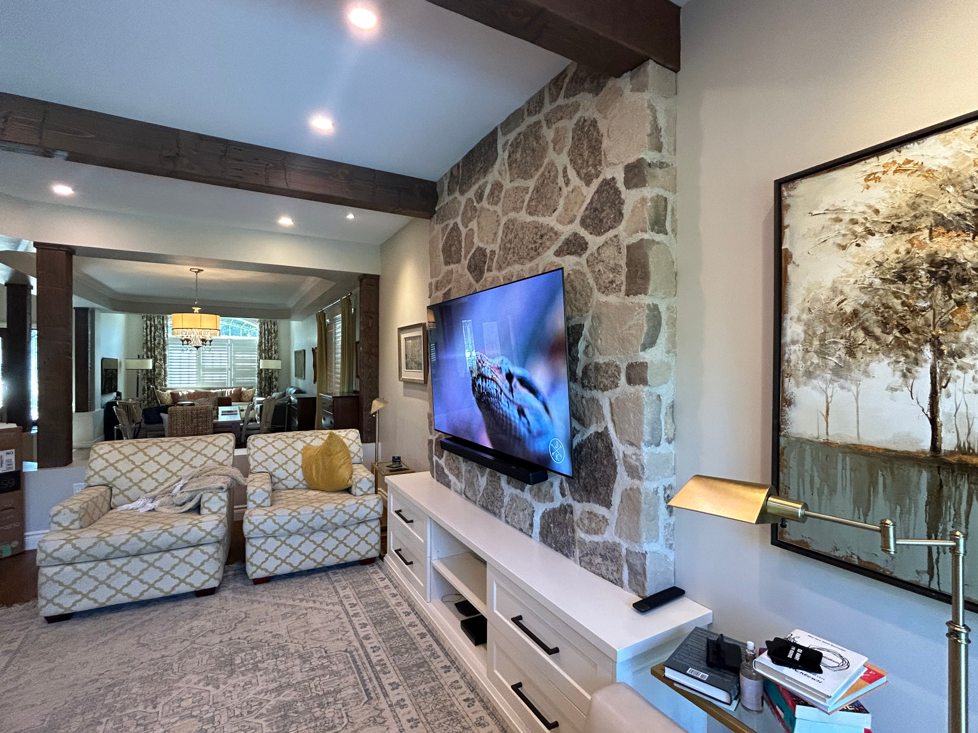 Wall-mounted TV on natural stone feature wall with concealed soundbar