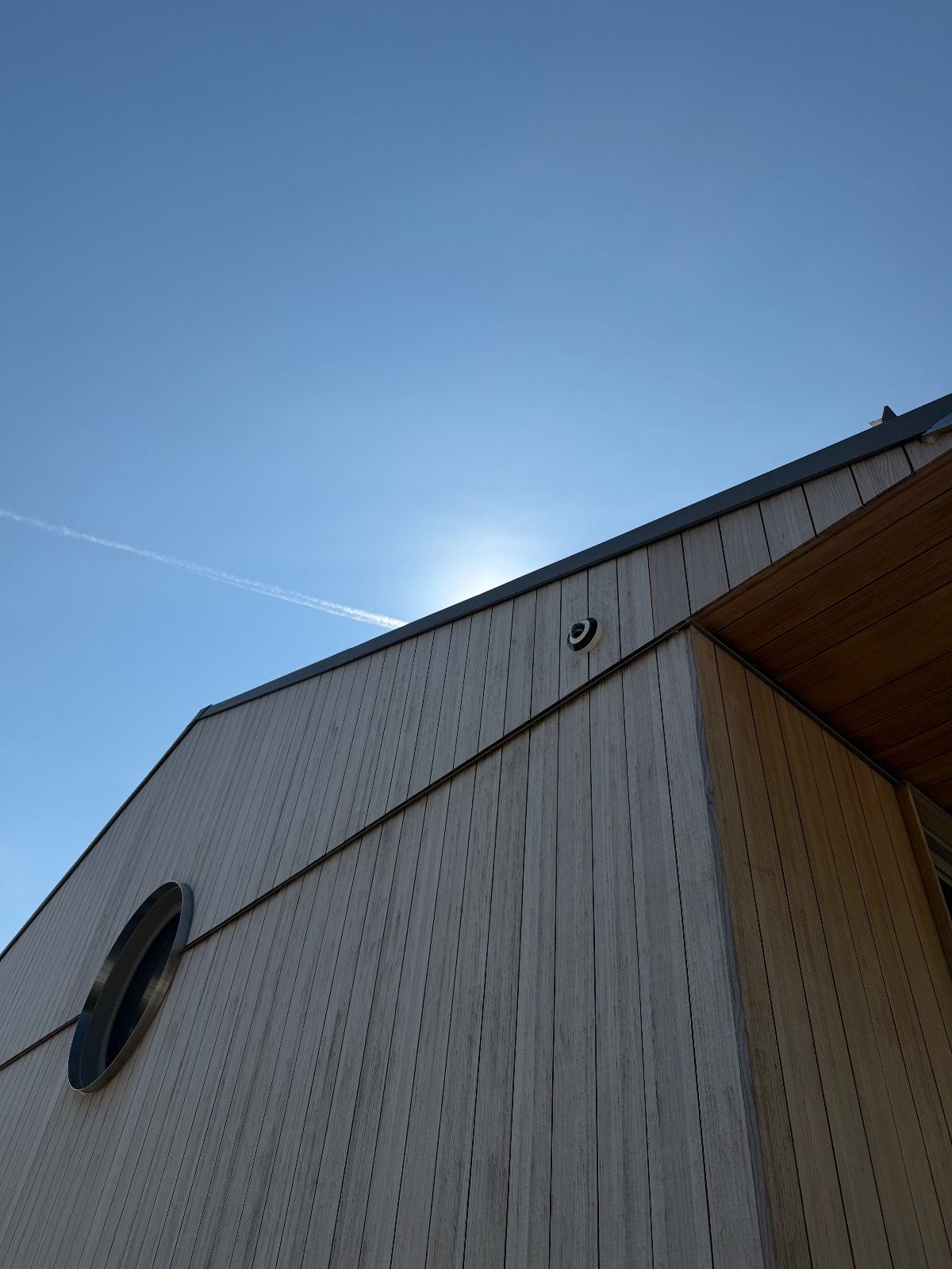 Fisheye camera on a modern wood-clad home