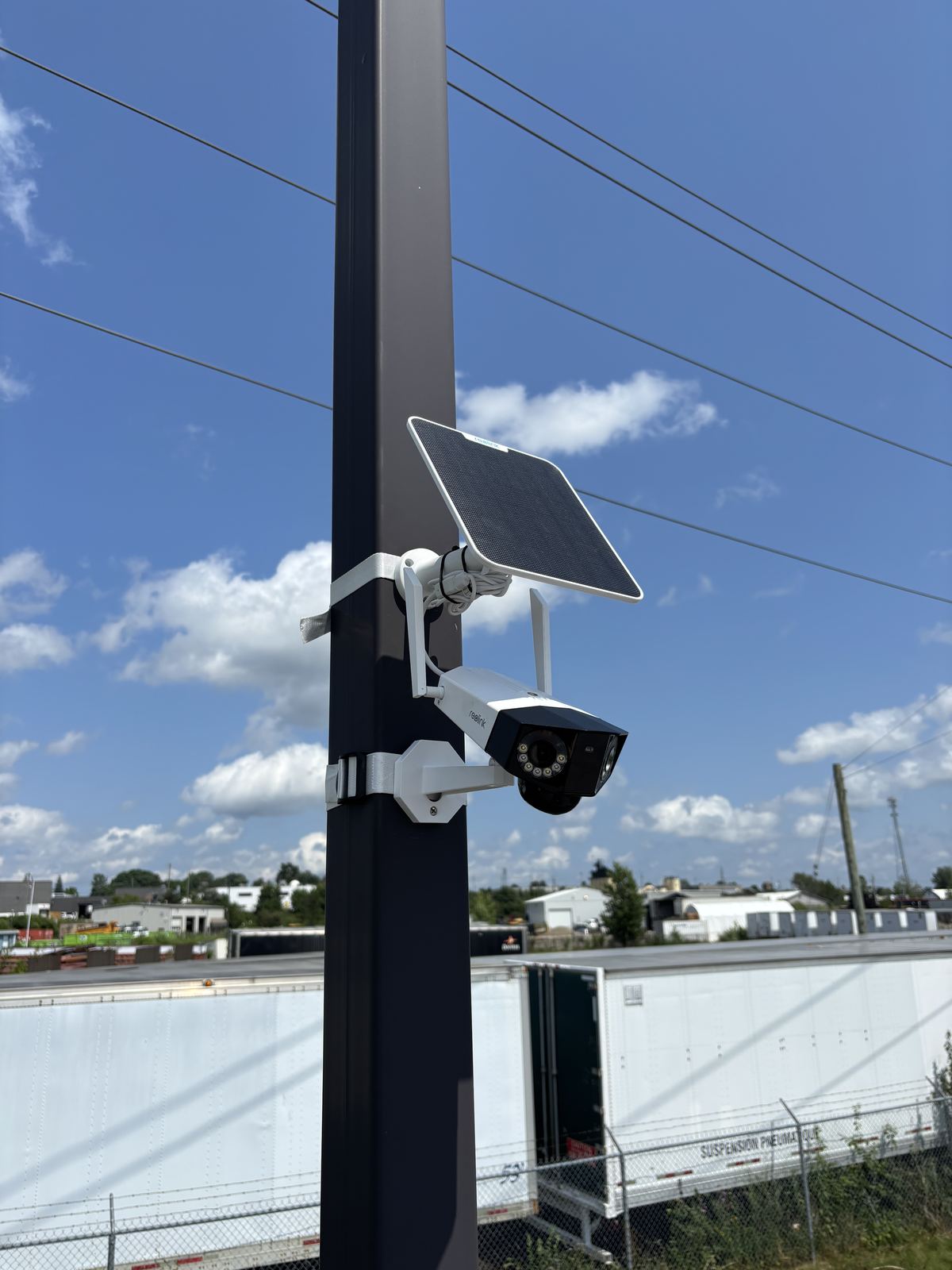 Solar-powered security camera pole-mounted over a trailer yard