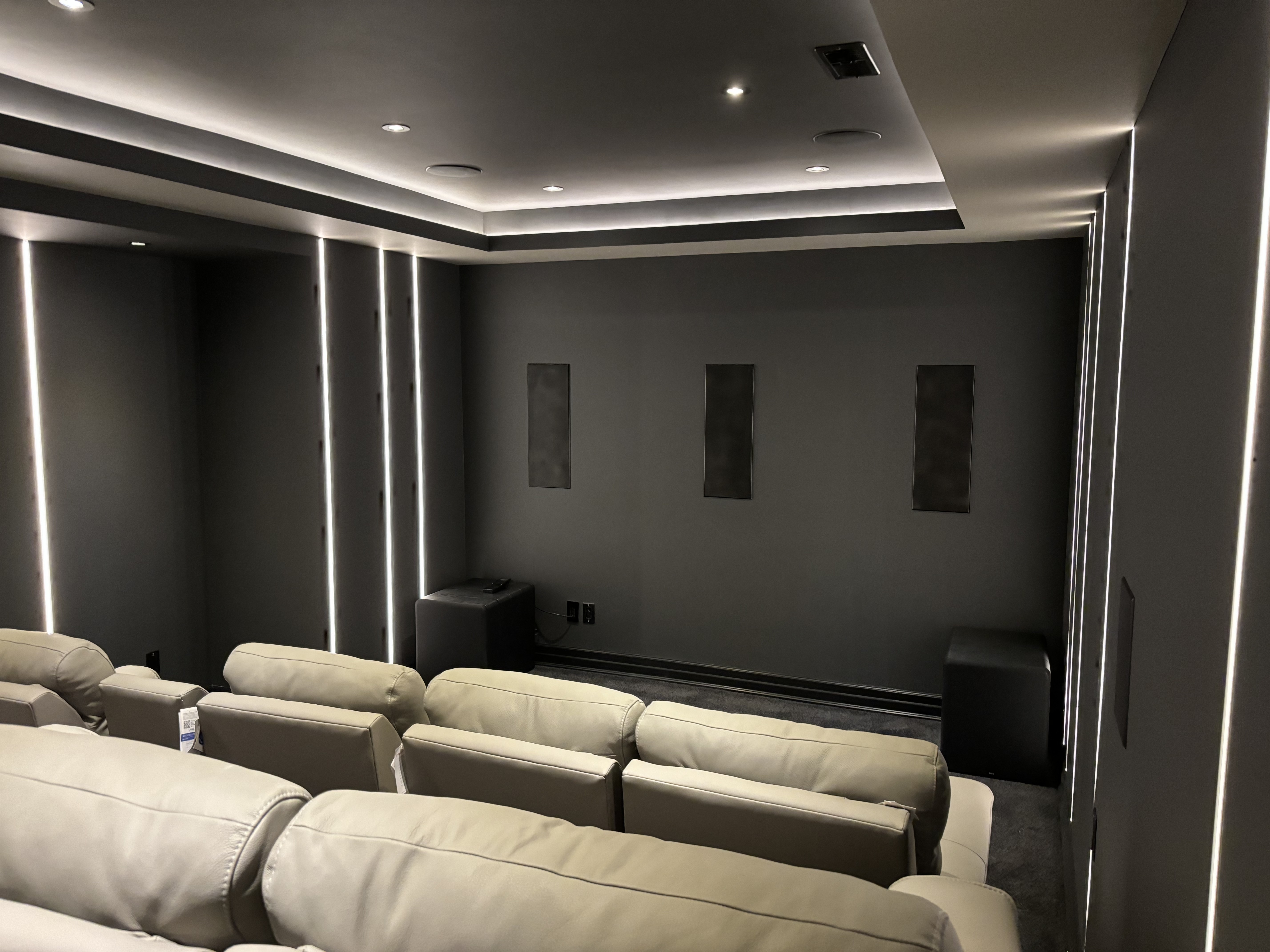 Wide view of the finished dedicated home theatre with tiered seating