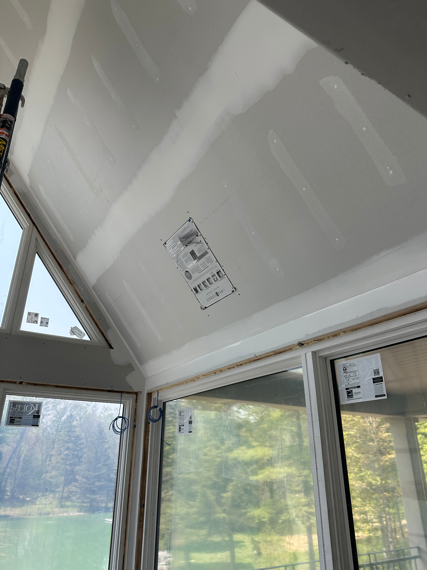 Sonance Invisible Series speaker template mounted flush into vaulted ceiling drywall