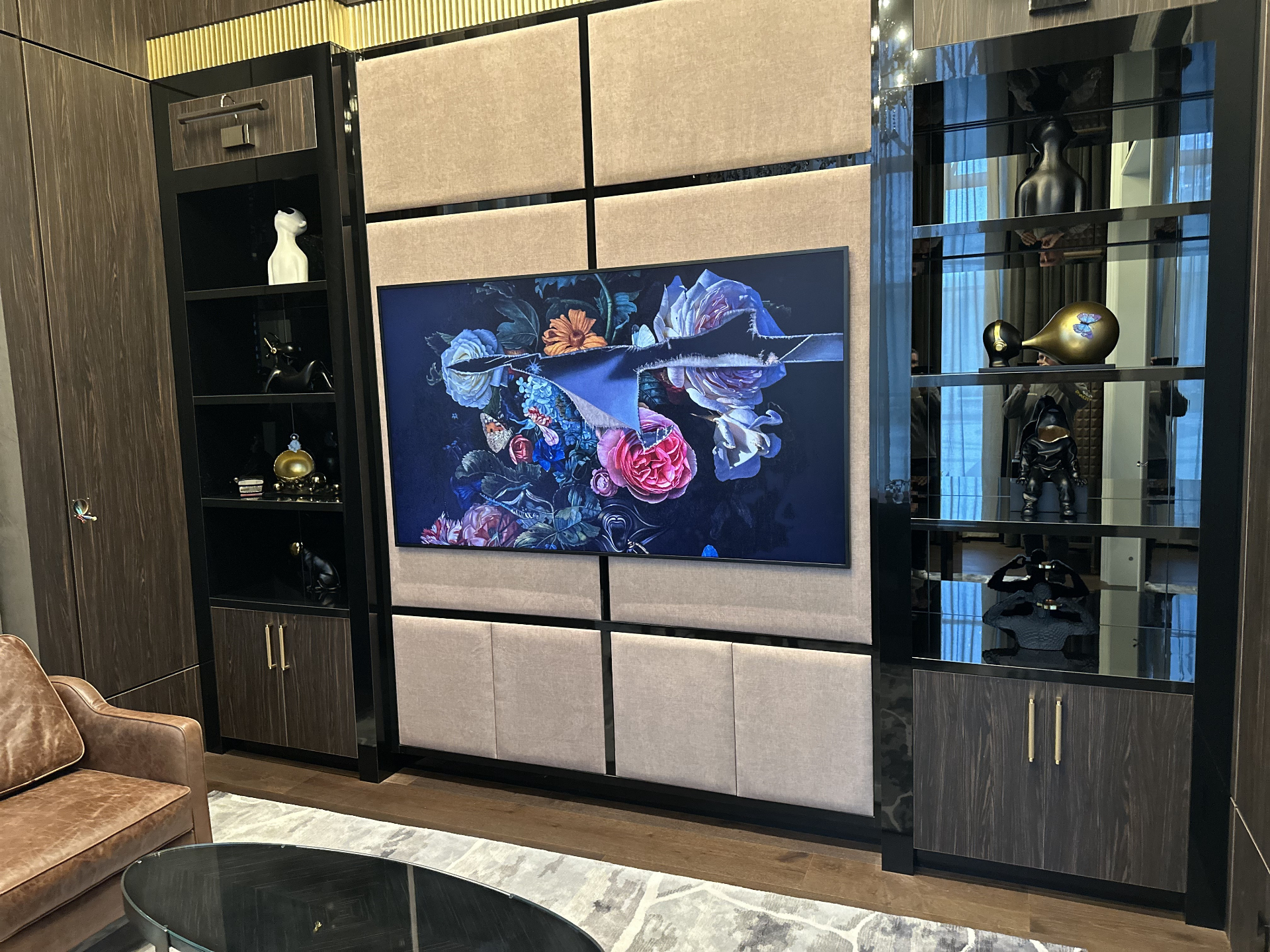 Luxury millwork feature wall with framed television and integrated accent lighting