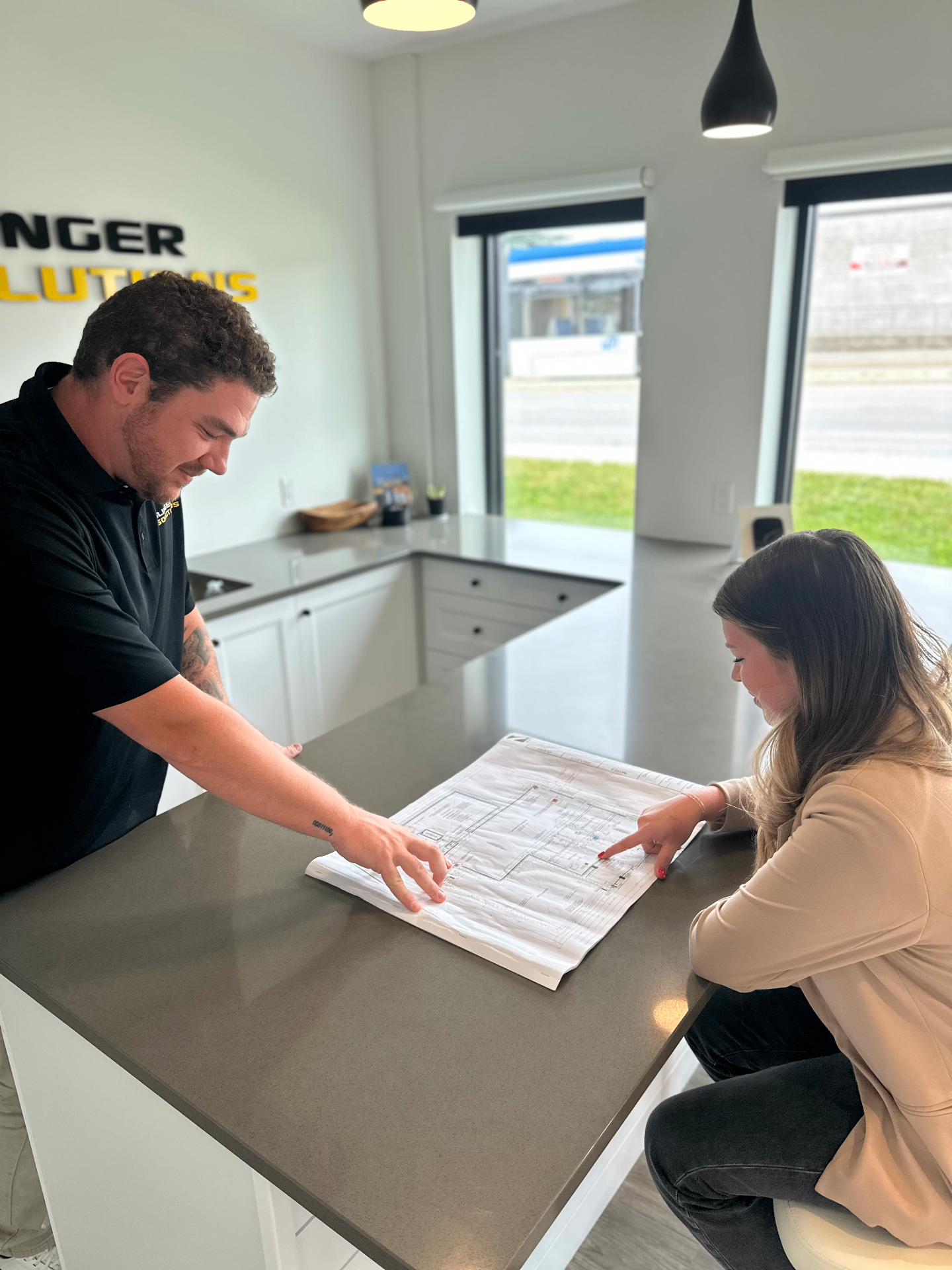 Slinger Solutions team reviewing plans with client